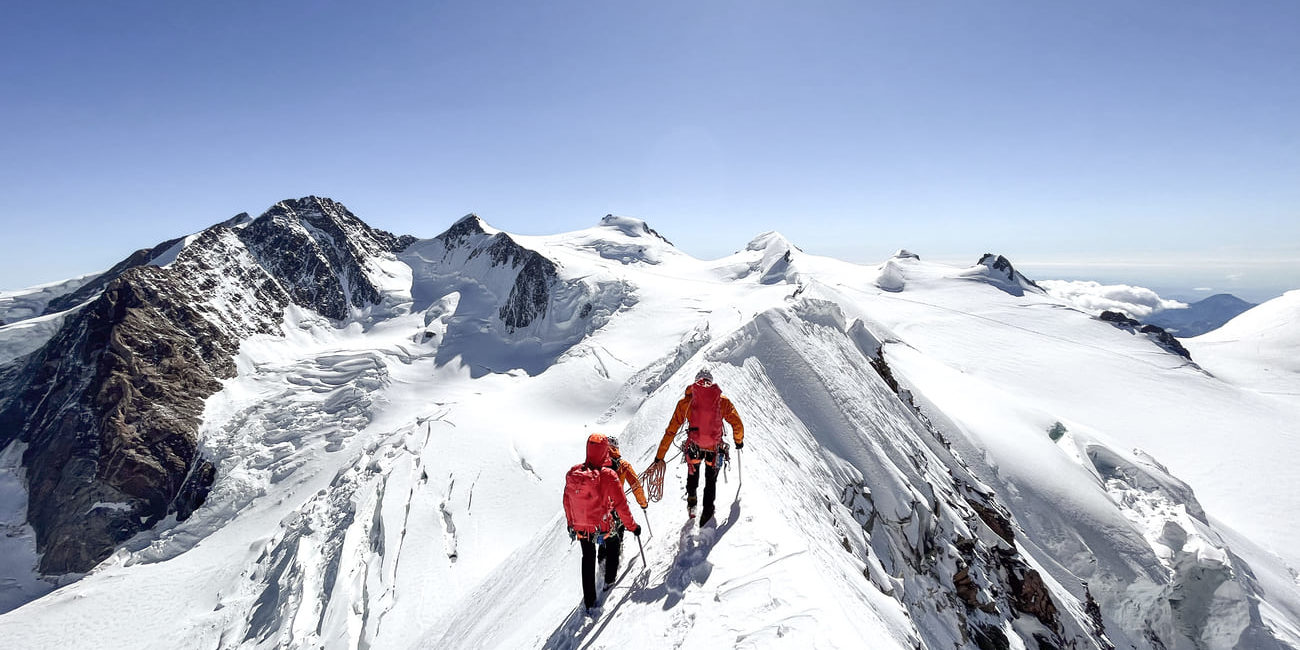 Der ausgesetzte Grat am Lyskamm. Im Hintergrund die Dufourspitze, die Zumsteinspitze, die Capanna Regina Margherita, Parrotspitze und Corno Nero.